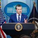Trump’s Defense Chief Draws Red Line: Iran’s Next Move? Government official speaking at a podium in the White House press briefing room