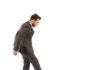 A man in a suit stepping towards a large bear trap
