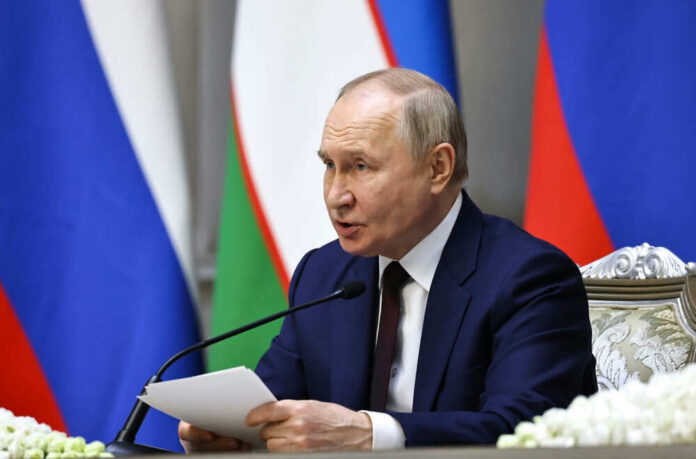 2495936651 Man speaking at conference with flags in background