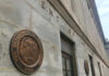 Exterior view of the Department of the Treasury building with a bronze plaque