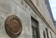 Exterior view of the Department of the Treasury building with a bronze plaque