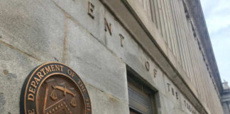 Exterior view of the Department of the Treasury building with a bronze plaque