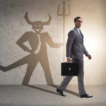 Businessman walking with a briefcase, shadow depicting a devil figure