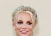 Britney Arrested — Hollywood Predators Close In Woman in a red dress smiling at an event