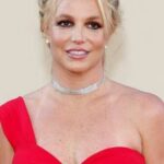 Woman in a red dress smiling at an event