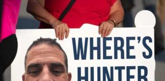 A protest sign asking 'WHERE'S HUNTER BIDEN' with a large photo of a man