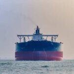 Large cargo ship navigating through the ocean