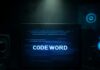 A laptop displaying the word 'CODEWORD' in blue digital text against a dark background