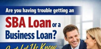 Two professionals discussing loan options at a desk with money in the foreground