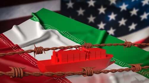 A red cargo ship on a background of Iranian and American flags with barbed wire