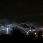 A dramatic lightning storm illuminating the night sky