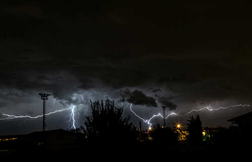 A dramatic lightning storm illuminating the night sky