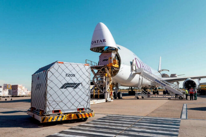 2076591514 Cargo airplane being loaded with shipping containers at an airport