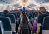 Airplane cabin interior with passengers seated inside