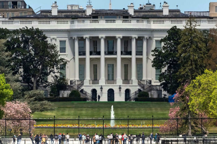 The White House with tourists in the foreground.