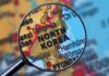A magnifying glass focusing on the North Korea section of a map