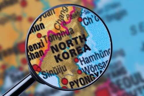 Map,Of,North,Korea,Through,Magnifying,Glass A magnifying glass focusing on the North Korea section of a map