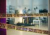 Explosive Claim: Nurse’s Shocking Death Broadcasted? Police crime scene tape blocking an area with investigators in the background