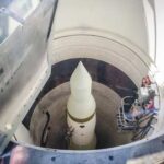 View of a missile inside a silo with maintenance equipment