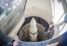 View of a missile inside a silo with maintenance equipment