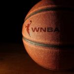 Close-up of a basketball with a logo in low light
