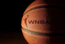 Close-up of a basketball with a logo in low light