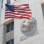 American flag waving in front of a United States court house