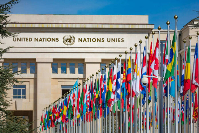 1193208634 United Nations building with numerous flags displayed