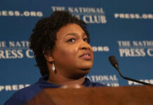 Supermodel Bombshell Hits Elite Boss Person speaking at National Press Club event