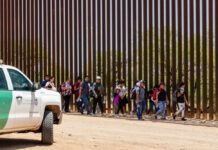 Child Pipeline Chaos Exposed Border Patrol vehicle near group of people walking