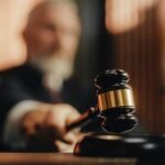 A judge holding a gavel in a courtroom setting