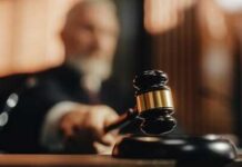 A judge holding a gavel in a courtroom setting
