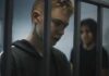 Texas Track Meet Turns Deadly Two young individuals in a detention setting, one looking down and the other in the background