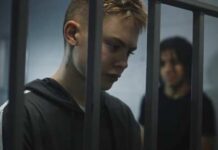 Texas Track Meet Turns Deadly Two young individuals in a detention setting, one looking down and the other in the background