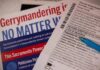 Close-up of election materials including a ballot and informational flyers
