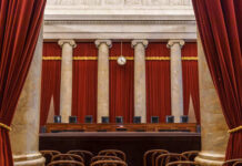 Horror In Key Largo Interior view of a courtroom with red curtains and marble columns