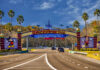 Walt Disney World entrance road with archway and characters.