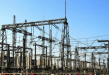 Grid Attack Warnings Mount — What’s Missing? Electrical substation with metal towers and wires.