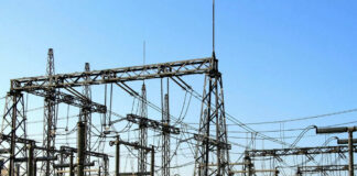 Electrical substation with metal towers and wires.