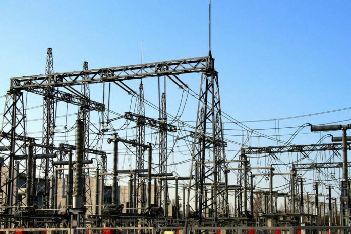 2398018651 Electrical substation with metal towers and wires.