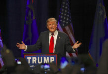 Hollywood Meltdown Hits Trump—What’s She Hiding? Man speaking at a podium with American flags.