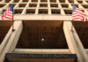 Exterior view of the J. Edgar Hoover FBI Building with American flags
