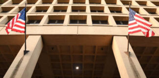 Exterior view of the J. Edgar Hoover FBI Building with American flags