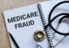 Notebook with the words 'MEDICARE FRAUD' and a stethoscope