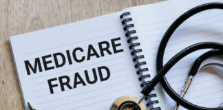 Notebook with the words 'MEDICARE FRAUD' and a stethoscope