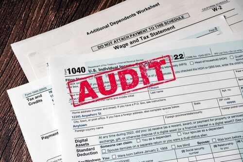 1040,Tax,Form,With,Red,Audit,Stamp.,Concept,Of,Tax Tax forms with an 'AUDIT' stamp prominently displayed