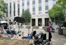 Community Hero Unmasked — Parents Rattled Media equipment and journalists outside a courthouse