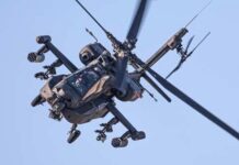 Trump’s Iran Blitz Leaves One Chilling Question An Apache helicopter flying in the sky with visible rotor blades