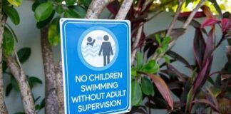 Sign indicating no children swimming without adult supervision