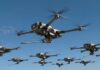 Army’s $500M Drone Gamble A swarm of drones flying in a clear blue sky